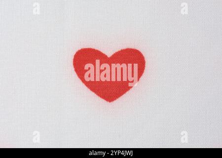 close-up of red cute heart on white fabric surface with textured background, love romantic and valentines day pattern Stock Photo
