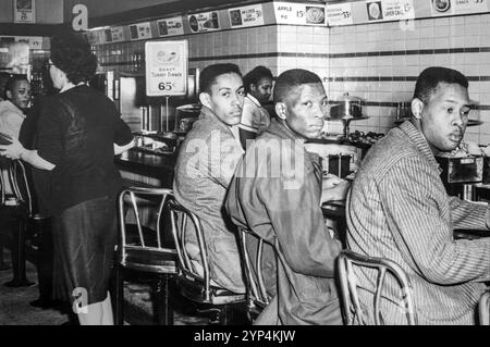 Students from the North Carolina Agricultural and Technical State University at the Greensboro sit in at Woolworths lunch counter in February 1960. The  Greensboro sit-ins were a civil rights protest against the whites only policy Stock Photo