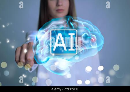 Artificial intelligence. Woman touching virtual brain with AI abbreviation on grey background, closeup Stock Photo