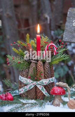 advent arrangement with a red candle, cones and coniferous branches Stock Photo