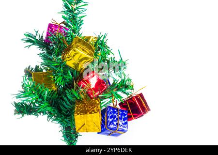 A vibrant Christmas tree branch decorated with colorful ornaments and gift boxes, set against a clean white background. Stock Photo