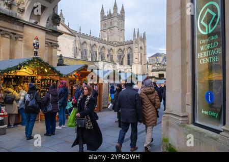 Bath, UK, 28th November 2024. Shoppers are pictured as they enjoy the opening day of Bath's Christmas market. Each year the streets surrounding the Roman Baths and Bath Abbey are home to over 220 stalls packed full of Christmas gifts. The award winning christmas market attracts shoppers from all over Europe. Credit:  Lynchpics/Alamy Live News Stock Photo