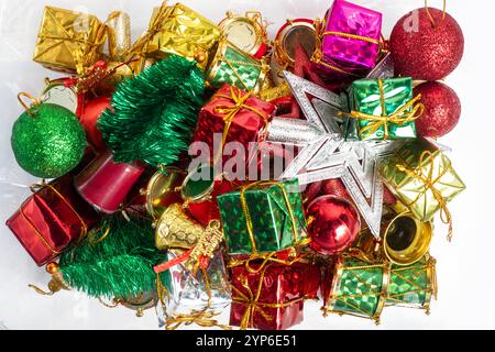 A cheerful collection of festive Christmas decorations featuring piles of colorful ornaments, glittering baubles, and beautifully wrapped gifts. Perfe Stock Photo