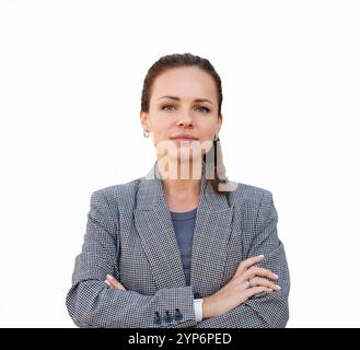 Isolated professional Caucasian woman in suit jacket arms crossed looking confidently at the camera. Stock Photo