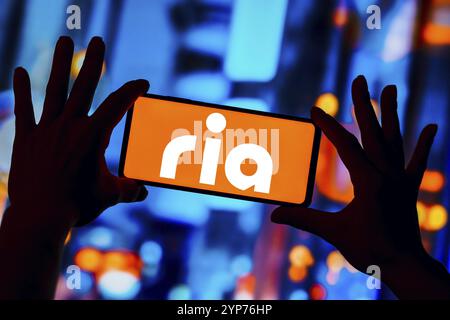 In this photo illustration, the Ria Money Transfer logo is displayed on a smartphone screen Stock Photo