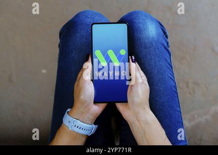 In this photo illustration, the Waymo logo is displayed on a smartphone ...
