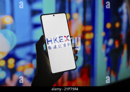 In this photo illustration, the Hong Kong Stock Exchange (HKEX) logo is displayed on a smartphone screen Stock Photo