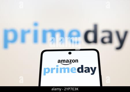 In this photo illustration, the Amazon Prime Day logo is displayed on a smartphone and in the background Stock Photo