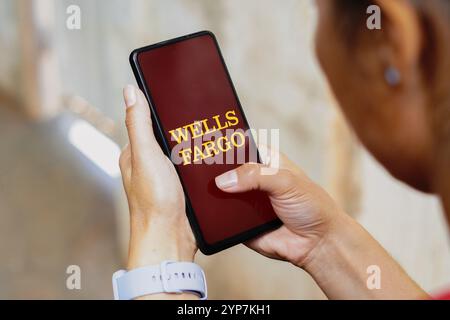 In this photo illustration, the Wells Fargo logo is displayed on a smartphone screen Stock Photo