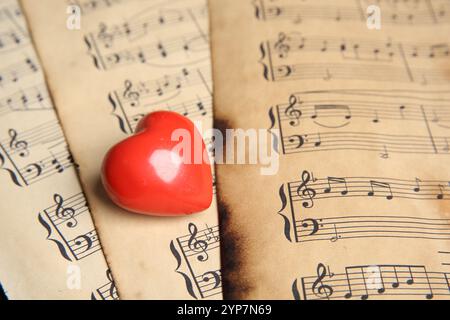 Heart figure on musical note sheets, closeup Stock Photo