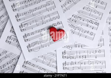 Heart figure on musical note sheets, top view Stock Photo