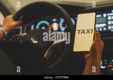 In this photo illustration, the Taxi logo is displayed on a smartphone screen Stock Photo