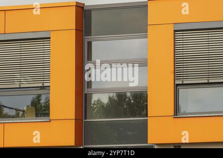 Ultra modern office building with windows and orange walls Stock Photo