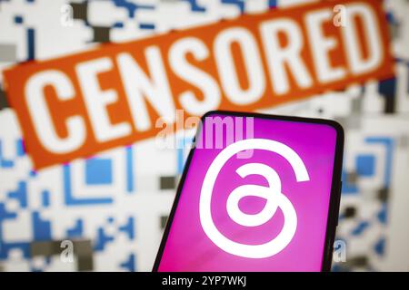 In this photo illustration the Threads logo is displayed on a smartphone and a red alerting word censored on the blurred background Stock Photo