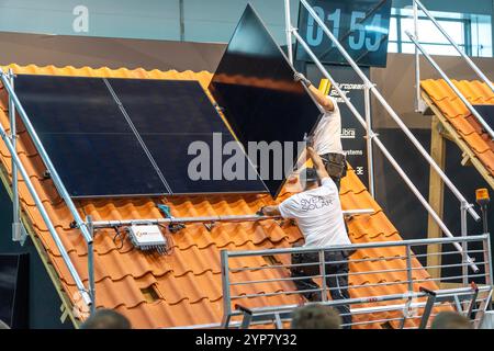 Presentation of the rapid installation of a solar system on a residential house with a pitched roof, in the form of a competition, European Solar Game Stock Photo