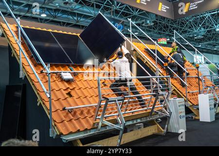 Presentation of the rapid installation of a solar system on a residential house with a pitched roof, in the form of a competition, European Solar Game Stock Photo