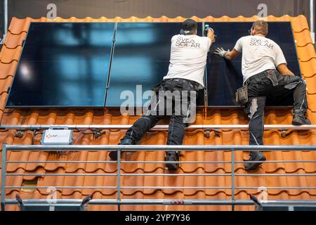 Presentation of the rapid installation of a solar system on a residential house with a pitched roof, in the form of a competition, European Solar Game Stock Photo