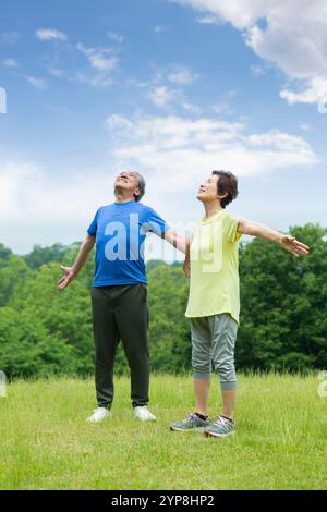 Senior couple taking a deep breath Stock Photo