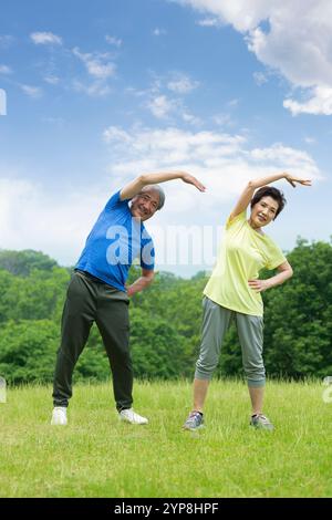 Couple doing gymnastics outdoors Stock Photo - Alamy