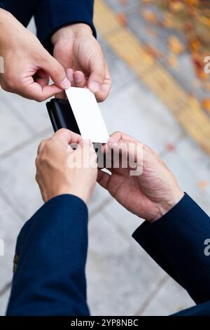 Hand holding a business card exchanging Stock Photo
