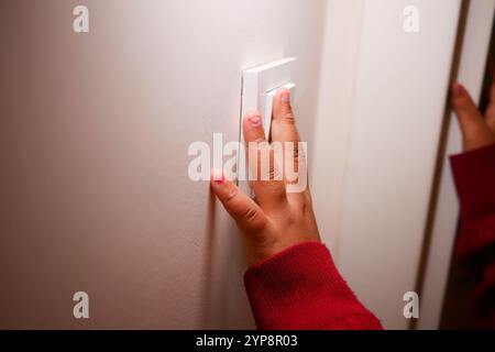 child finger turning on lighting switch with copyspace  Stock Photo