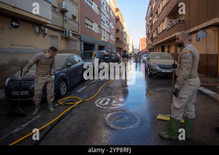 Valencia, Spain. 28th Nov, 2024. Army personnel clean the streets of Paiporta in the south of Valencia. On November 29, one month has passed since the Isolated Depression at High Levels (DANA) that hit the towns in the south of the Spanish city of Valencia at the end of October and which, in addition to causing millions in economic damages, claimed the lives of more than 200 people. Credit: SOPA Images Limited/Alamy Live News Stock Photo