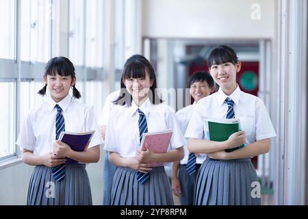 Junior high school students walking in corridor Stock Photo
