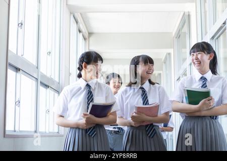 Junior high school students walking in corridor Stock Photo