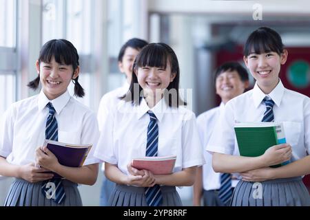 Junior high school students walking in corridor Stock Photo