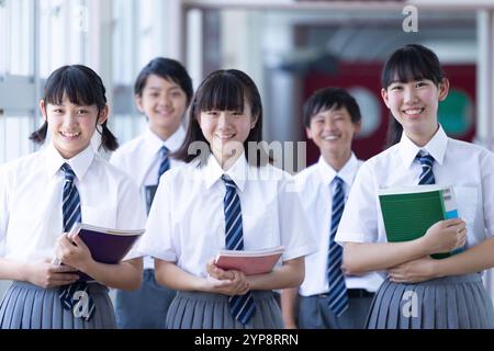 Junior high school students walking in corridor Stock Photo