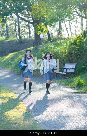 High school student running walking in park Stock Photo