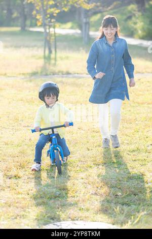 Kick Riding Cycle Boy riding kick bike Stock Photo - Alamy