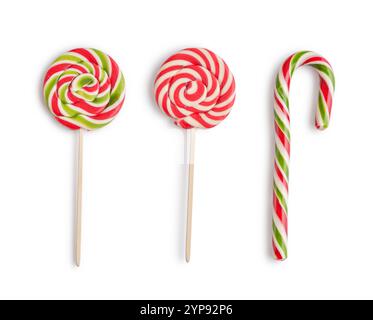 Red, green and white striped candy cane and lollipops isolated on a white background, top view Stock Photo