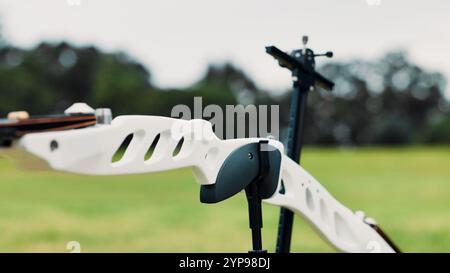 Archery, sports and closeup of bow in field for target practice, challenge and competition outdoors. Shooting range, crossbow and equipment for Stock Photo