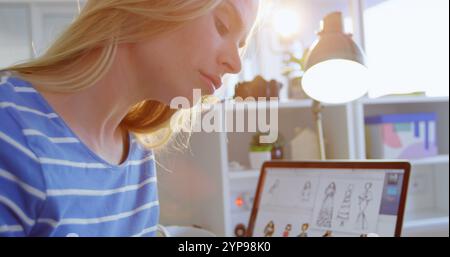 Side view of Caucasian female fashion designer working at desk in office Stock Photo