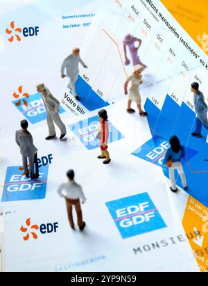 People interacting with energy documents and graphs (EDF) France Stock Photo