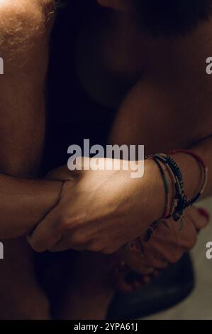 Colored traditional Thai bracelets on men's wrists Stock Photo