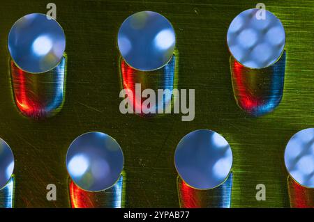 Holes in stainless steel with red, green and blue light wash Stock Photo
