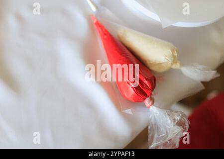 Process of making cake, white and red cream ready to be decorating Stock Photo