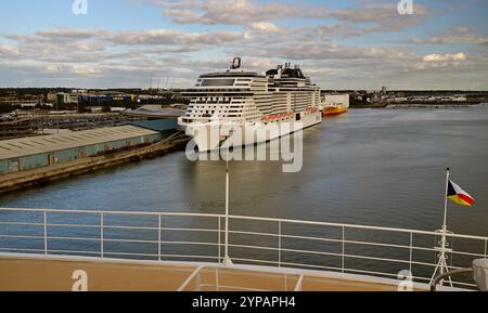 MSC cruise ship Virtuosa and Grimaldi Ro-Ro cargo ship Grande Ghana moored at Southampton. (Seen from a P&O cruise ship). Stock Photo