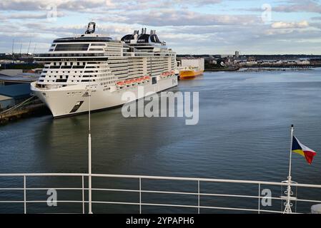 MSC cruise ship Virtuosa and Grimaldi Ro-Ro cargo ship Grande Ghana moored at Southampton. (Seen from a P&O cruise ship). Stock Photo