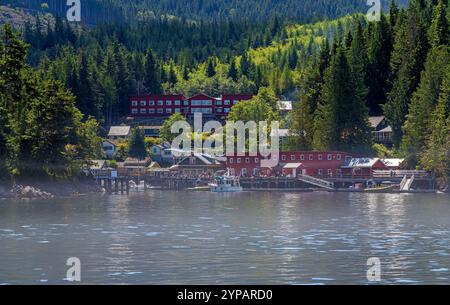 Telegraph Cove city marina and docks with people going on whale watching adventure, Vancouver Island, Canada. Stock Photo