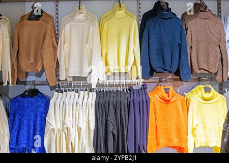 stylish multi-colored women's sweaters. Preparing for the cold season Stock Photo