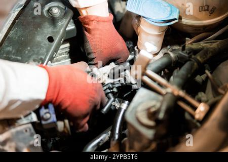 Mechanics Working on an Engine Component in a Dimly Lit Garage Stock ...