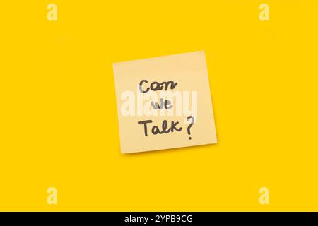 Can we talk handwritten on a yellow sticky paper on a yellow background with copy space Stock Photo
