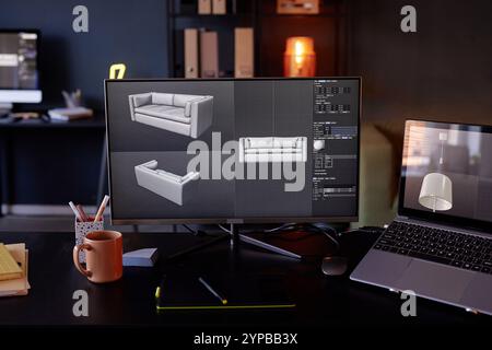 Monitors displaying 3D models of a sofa, alongside various software tools and options Photographed in well-lit modern office, with laptop, notebook, and coffee mug on desk Stock Photo