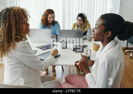 Collaborating in Modern Workspace with Diverse Team Stock Photo