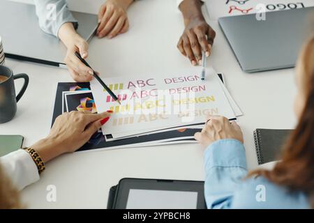 Collaborating on Colorful Design Project in Office Stock Photo