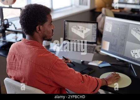 3d Man Using A Computer A modern office space with multiple 3D printers and spools of filament ...