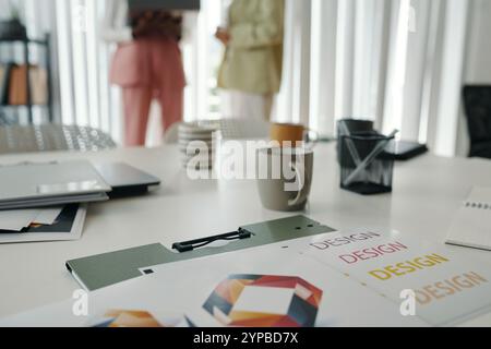 Collaborating in Modern Office Setting with Design Documents Stock Photo